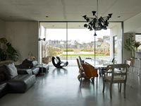 Contemporary concrete open plan living space with dining area