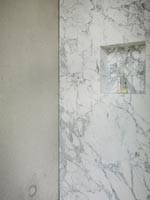 Alcove shelf in marble wall of modern bathroom 