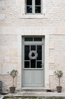 Wreath on front door of country house 