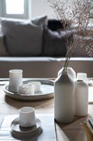 Detail of white ceramics and crockery on wooden table 