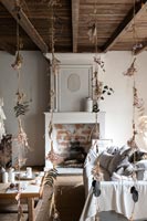 Decorative dried flower hangings from ceiling of country living room 