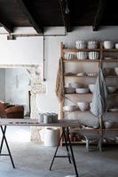 Display of white ceramics on wooden shelves