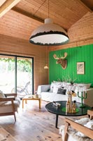 Green painted feature wall in modern country living room 