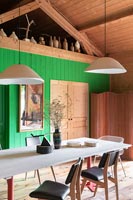 Modern country dining room with green wooden painted feature wall 