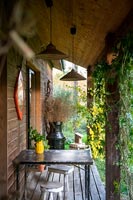 Tiny seating area on veranda of small country house 