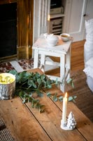 Simple decorations and white Christmas candlestick on coffee table - detail