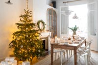 White dining room decorated for Christmas 