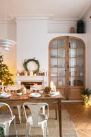 White and wood dining room decorated for Christmas 