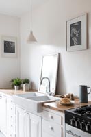 Butler sink in modern white kitchen 