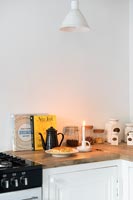 Candle on worktop of modern kitchen 