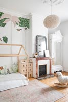 Modern childs bedroom with fireplace and mural wall 