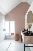 Modern bathroom with dusky pink painted feature wall 
