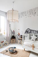 Childrens room with animal mural on walls 