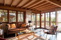 Country living room with sunshine pouring through windows 