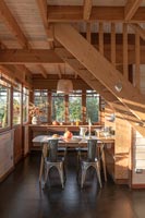 Dining area under wooden staircase 