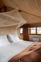 Country bedroom with mosquito net over the bed 