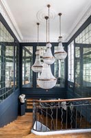 Display of chandeliers over classic staircase 