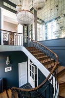 Classic staircase with mirrored feature wall and chandeliers 