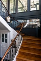 Black and white painted and mirrored walls on wooden staircase 