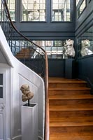 Classic style staircase with mirrors and black painted walls 