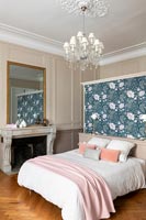 Floral feature wall at head of bed in classic bedroom 