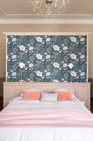 Floral wallpaper on feature wall behind bed 