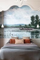 Painting above bed in classic style bedroom 