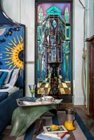 Colourful eclectic bedroom - unusual table and mirror detail 