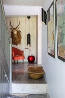Hunting trophy and chair at top of stairs 