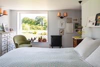 Large picture window in country bedroom 