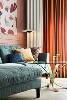 Blue sofa and orange curtains in modern living room 