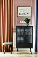 Small black cabinet and stool in modern hallway 