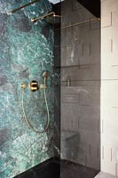 Green marbled decorative wall in modern shower cubicle 