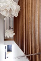 Wooden slatted balustrades at top of modern staircase 