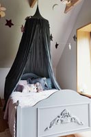 Dark grey canopy over pale grey wooden childrens bed 