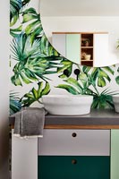 Modern bathroom with tropical leaf wallpaper 