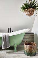 Modern bathroom with green roll top bath 