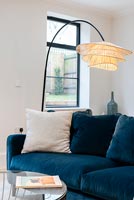 Floor lamp next to blue sofa in modern living room 