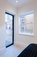 Glazed door to garden in modern bedroom 