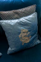 Blue and gold cushion with dragon motif 
