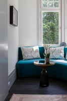 Curved sofa blue built-in to window alcove - snug sitting area 