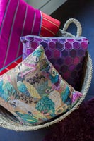Colourful cushions in basket 