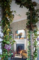 Christmas garland around mirror with reflection of fireplace 