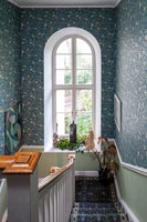 Blue patterned wallpapered walls on staircase 