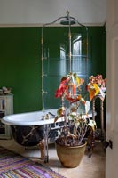 Vintage shower screen over roll top bath in eclectic bathroom 