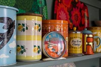 Colourful storage jars on kitchen shelf 