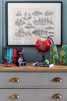 Toys on chest of drawers in childrens room 