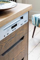Appliance hidden in wooden kitchen cabinet 