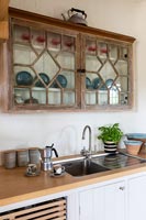 Decorative wooden wall mounted cabinet in country kitchen