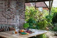 Decorative rusted metal hanging lamps over outdoor table 